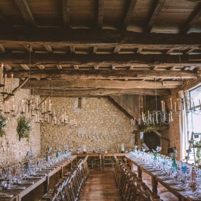 The Chai wedding reception room with two long tables and candle holders