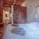 double room in the studio of La Léotardie with a double bed and a period wardrobe