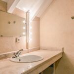 bathroom sink with mirror at Le Vignal La Leotardie