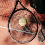 tennis player with racket and ball on a clay court